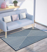 Machine washable blue area rug with geometric design.